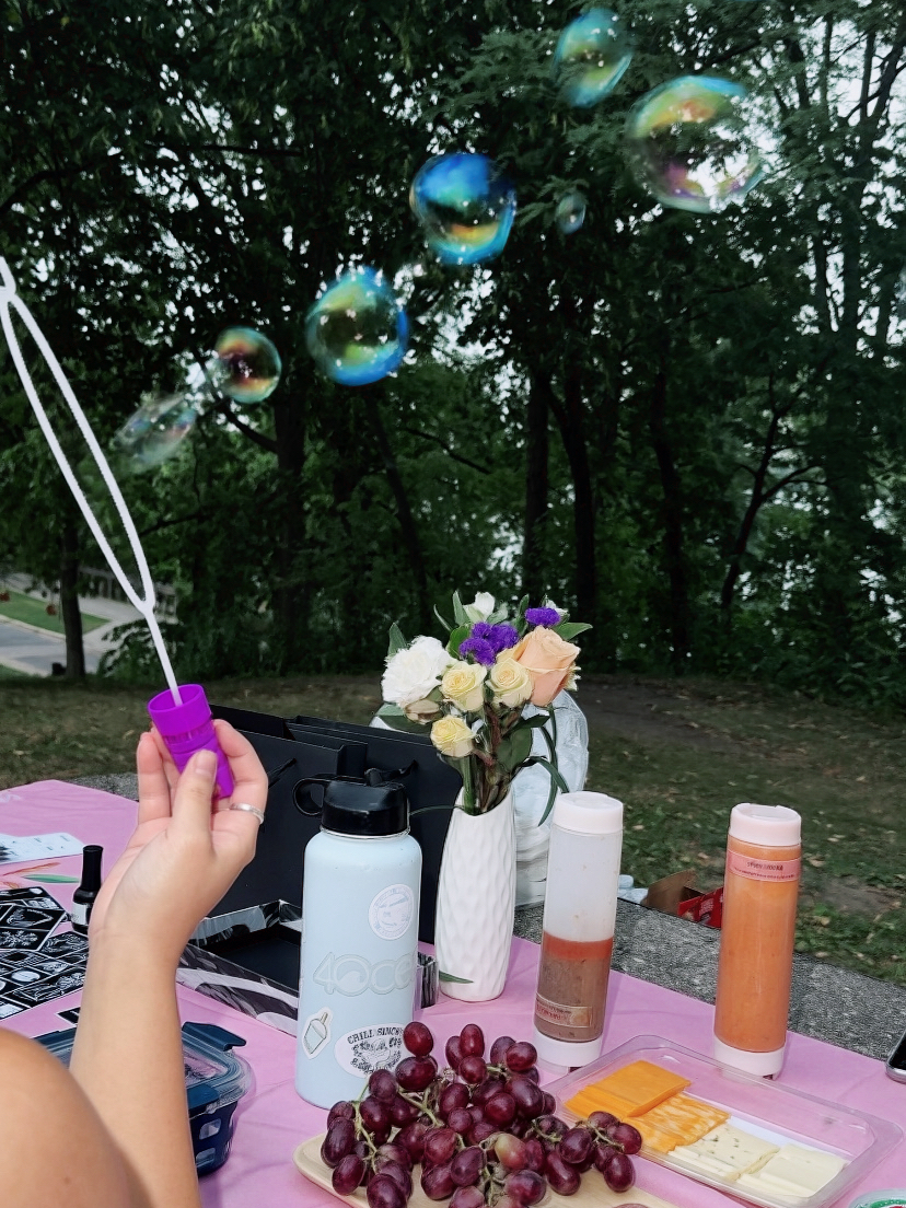 Bubbles, flowers, fruit, and conversation at an outdoor OMI picnic